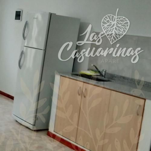 a kitchen with a refrigerator and a sign on the wall at Las Casuarinas in Pilar