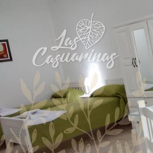 a bedroom with a bed with a sign that reads las lasendas at Las Casuarinas in Pilar