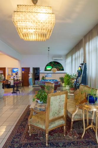 a living room with a couch and a table at Hotel Elefante Bianco in Crespellano