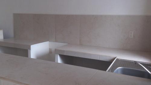 a kitchen with two benches and a sink at Hotel Albatros Palace in Manzanillo