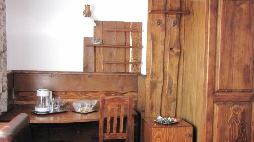 a room with a wooden table and a counter with a coffee maker at Villa Elitte Predeal in Predeal