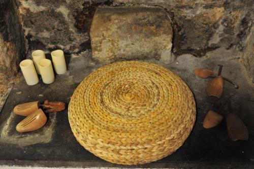 a wicker basket sitting next to a group of white candles at Casa Messi in Pitigliano