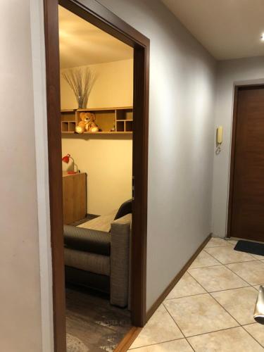 uma sala de estar com um espelho e um sofá em Apartament 9-te piętro em Lódź