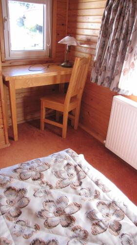 a bedroom with a desk and a bed and a chair at Villa Elitte Predeal in Predeal