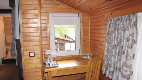 a wooden desk in a room with a window at Villa Elitte Predeal in Predeal