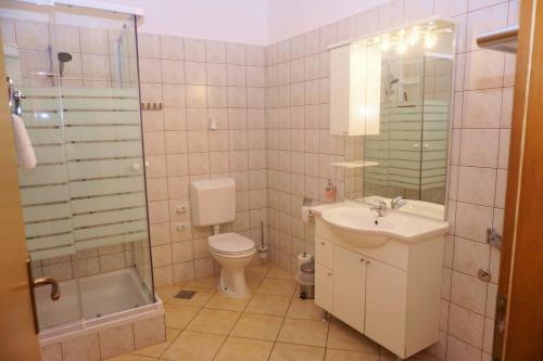 席烏倪的住宿－Olive House，浴室配有卫生间、盥洗盆和淋浴。
