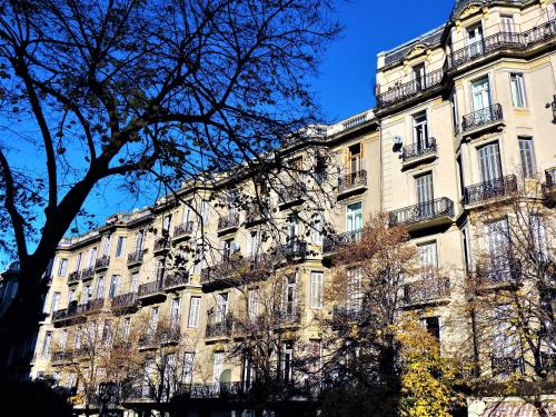 a large building with balconies on the side of it at Stylish duplex in Caseros Boulevard - San Telmo in Buenos Aires