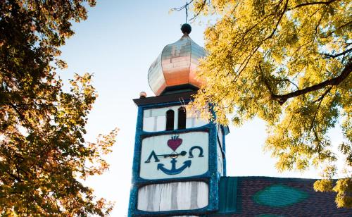 a tall clock tower with a sign on it at Ferienwohnungen Fam. Pabst in Maria Lankowitz