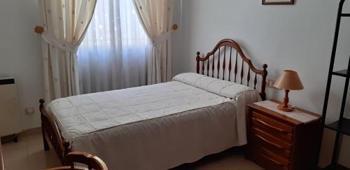 a bedroom with a bed and a dresser and a window at Casa Gazquez in Santo Tomé