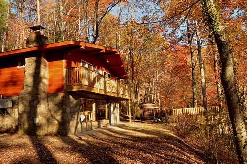 a building in the middle of a forest at #820 Honeymoon Hideaway in Gatlinburg
