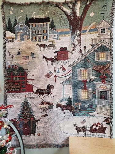 a pillow with a christmas picture on it at The Barn Inn Bed and Breakfast in Millersburg
