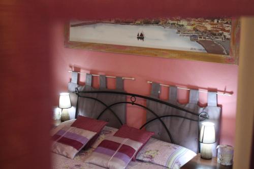 a bedroom with a bed with a picture on the wall at Aethalia Bed and Breakfast in Portoferraio