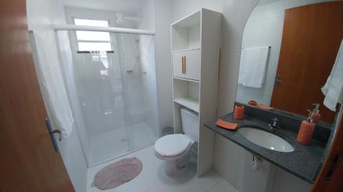 a bathroom with a shower and a toilet and a sink at Condomínio Residencial Tranquilidade na Beira do Rio in Paulo Afonso