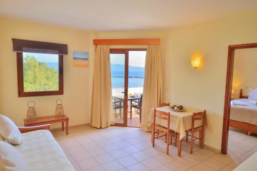 a hotel room with a bed and a table with a view at Maria Beach Hotel in Kissamos