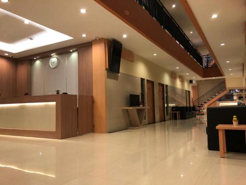 a large lobby with a television and a podium in a building at LCR HOTEL in Ende
