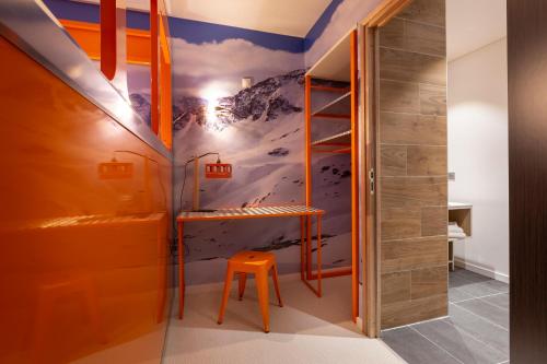 a bathroom with a mountain mural on the wall at Hotel Base Camp Lodge - Bourg Saint Maurice in Bourg-Saint-Maurice
