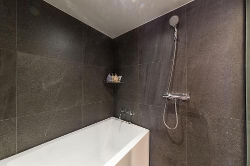 a bathroom with a bath tub and a shower at Incheon Airport Hotel Seattle in Incheon