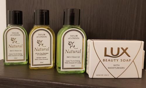 three bottles of soap sitting next to a box at Robin 7 Lodge City Centre in Nottingham