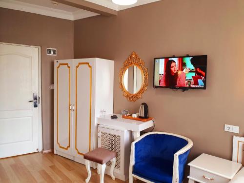 a bathroom with a vanity and a tv on the wall at Şehir Hotel Old City in Istanbul