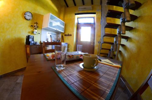 a table with a cup and glasses on top of it at Le Suite Bracciano in Bracciano
