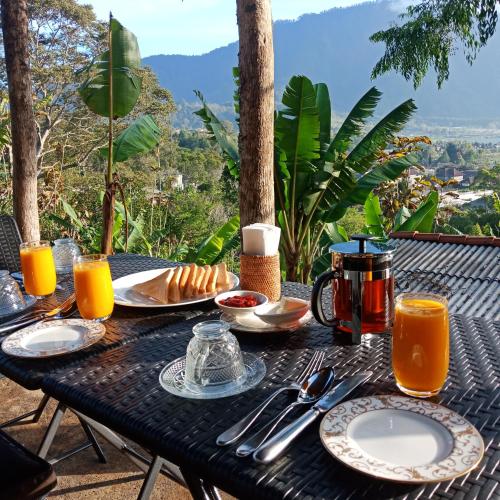 a black table with plates and utensils on it at ECO Bedugul adventurer camp in Bedugul