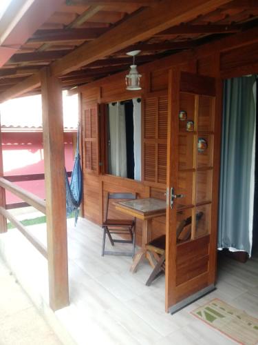 a room with a table and a wooden door at Chales do Antonio in São Pedro da Serra