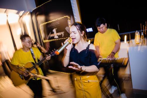 un grupo de personas cantando y tocando instrumentos en Marilyn Boutique Hotel Nha Trang en Nha Trang