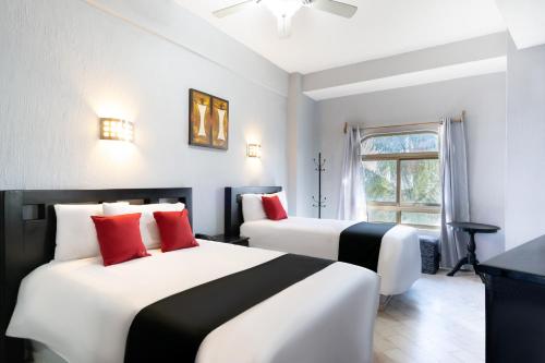 Una cama o camas en una habitación de Guadalajara Express Tonala