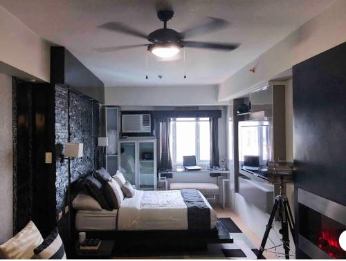 a bedroom with a bed and a ceiling fan at Modern Place of Style in Manila