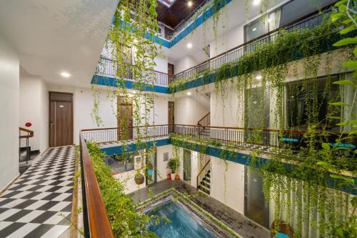 an indoor pool in a building with plants on the walls at The Nam An Villa Hoi An in Hoi An