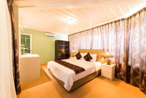 a bedroom with a bed and a sink in it at The Ocean Residence Langkawi in Kuah
