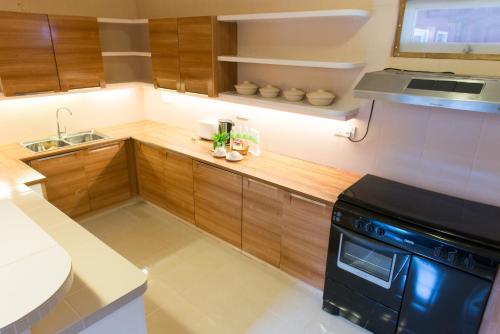 
a kitchen with a microwave and a sink at The Ocean Residence Langkawi in Kuah

