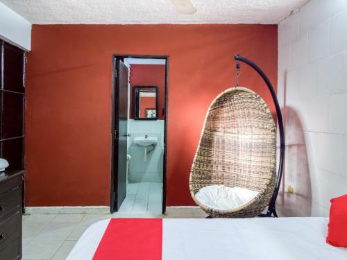 Habitación con cama y columpio de mimbre en Hotel Aventura, en Mérida