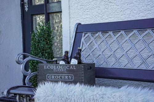 two bottles of wine sitting on a bench at Ferienapartment Christine in Simmerath