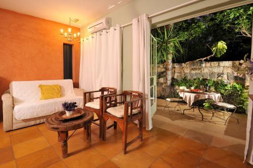 a living room with a couch and a table at Love & Lemons in Yesod Hamaala