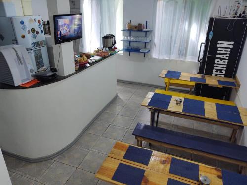 a store with two tables and a tv in a room at Mundo da Lua Hostel in Morro de São Paulo