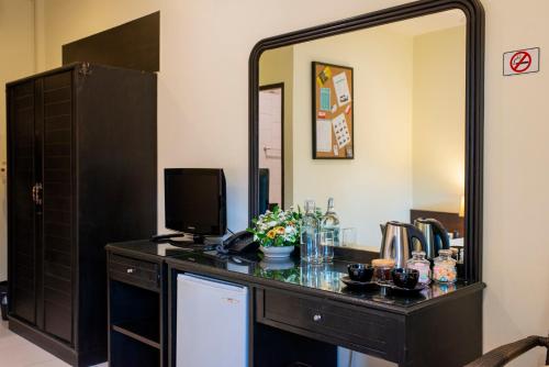 a dressing table with a television and a mirror at Lokal Phuket "Former K-Hotel" - SHA Extra Plus in Patong Beach