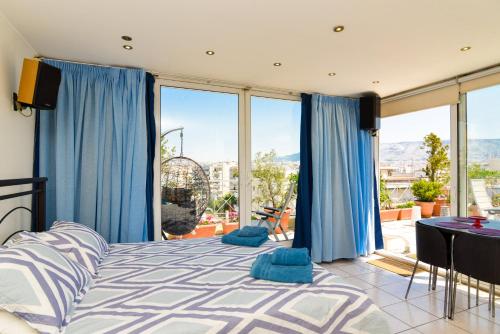 a bedroom with a bed with blue curtains and a balcony at Kalypso Apartment in Athens