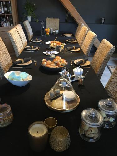 a long black table with food on top of it at Au Calme de Hosdent in Braives