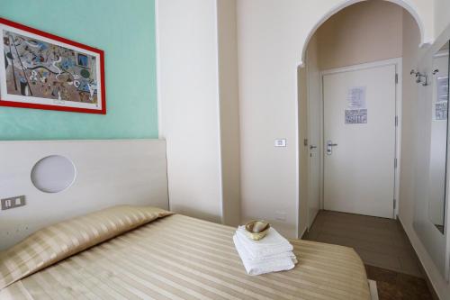 Un ou plusieurs lits dans un hébergement de l'établissement Hotel Happy