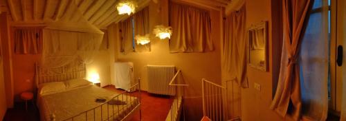 a small bedroom with a bed and a room with at Dimora San Lazzaro B&B in Lucca