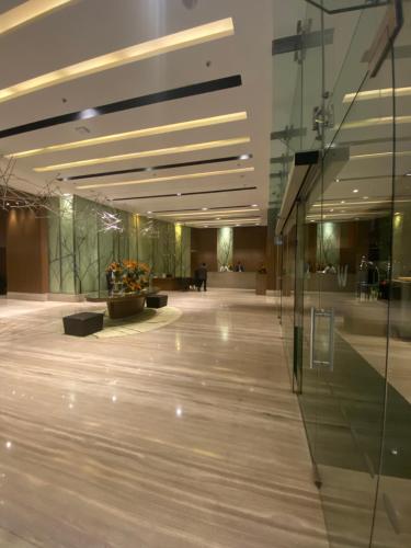 an empty lobby with a glass wall in a building at Welcomhotel by ITC Hotels, Richmond Road, Bengaluru in Bengaluru