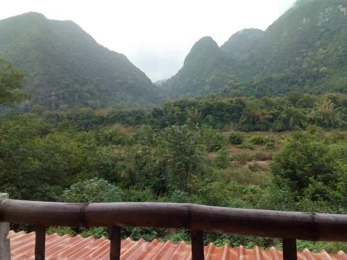 a view of a valley with mountains in the background at SuanPhao Guesthouse in Muang Ngoy