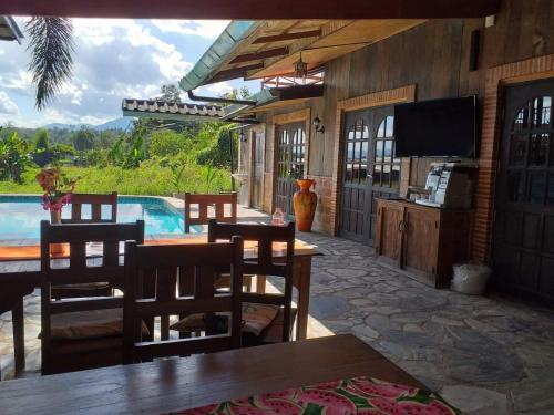 a patio with a table and chairs and a television at XPai in Pai