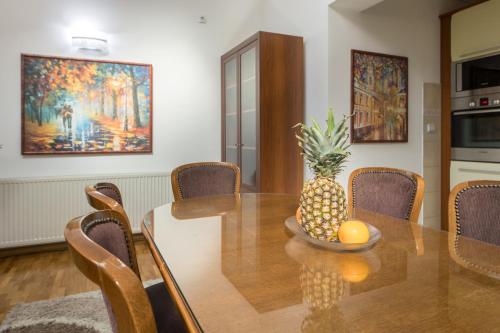 a dining room with a table with a pineapple on it at F Apartmani Kragujevac in Kragujevac