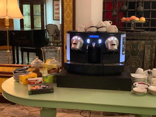 a table with a television with a skull on it at Hotel Ficocle in Cervia