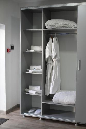 a closet with shelves with towels and a mattress at Del Mare семейный корпус in Kapchagay