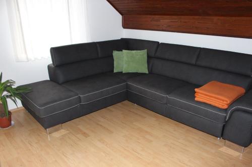 a black couch sitting in a living room at Apartma Maržič in Kranjska Gora