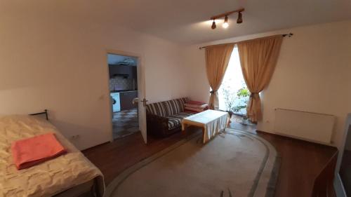 a bedroom with a bed and a couch and a table at Apartment Na Saharova in Ivano-Frankivsk