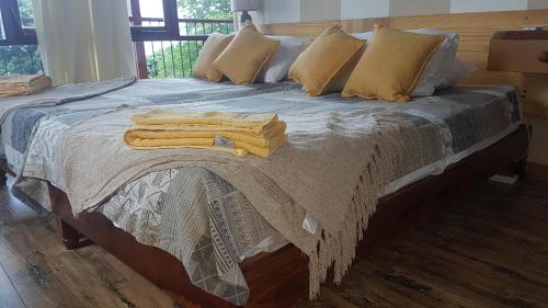 a bed with pillows and towels on top of it at Skyline View in Bel Ombre